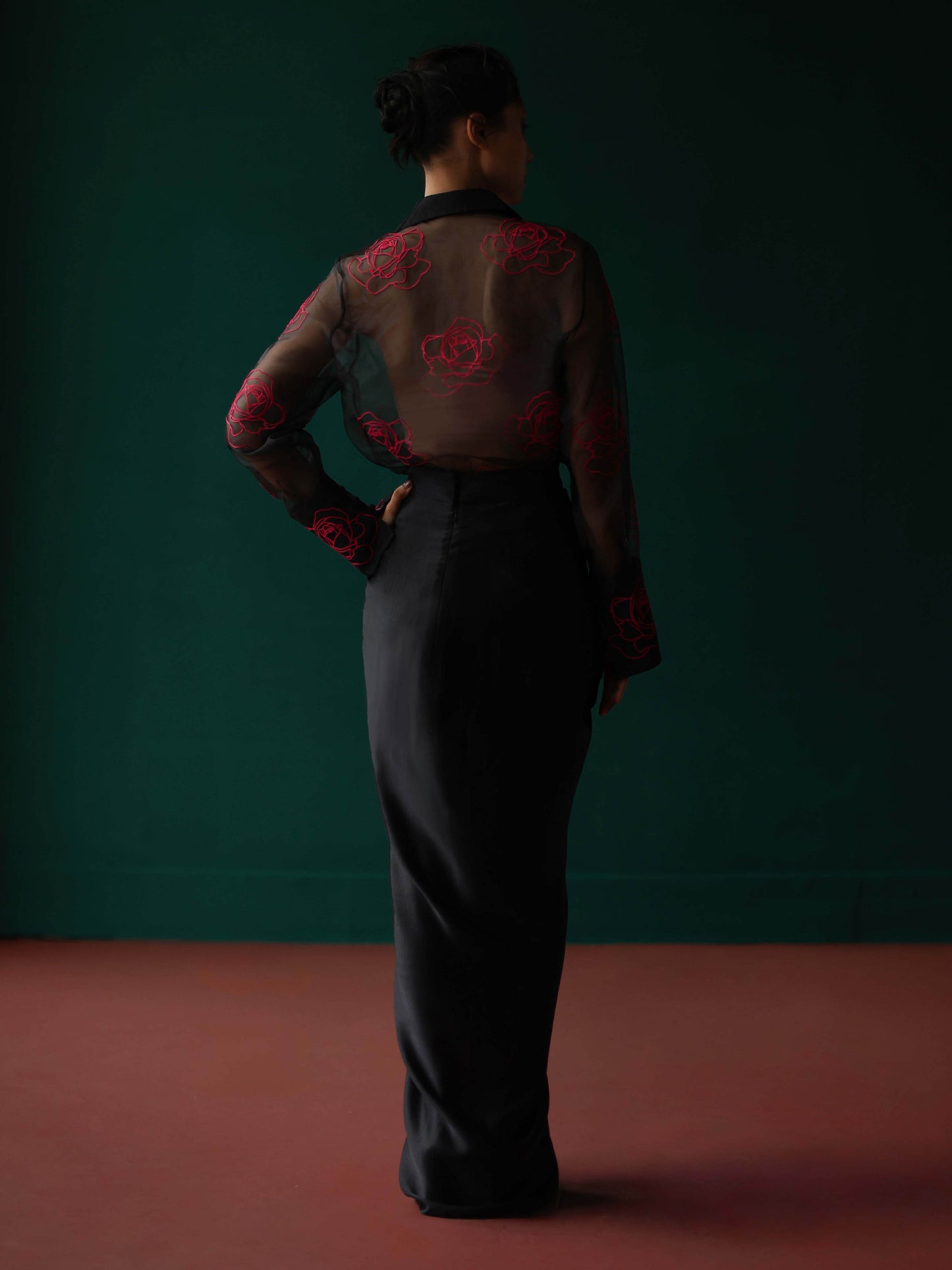 Sheer shirt with dimensional roses paired with twist skirt