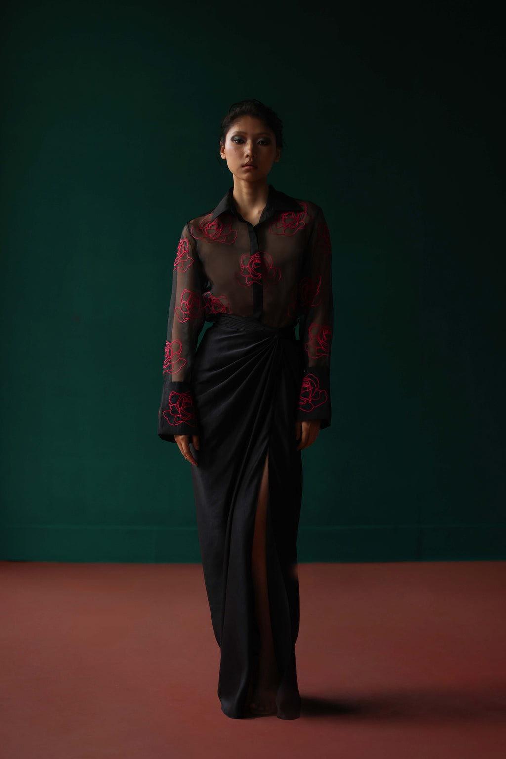 Sheer shirt with dimensional roses paired with twist skirt