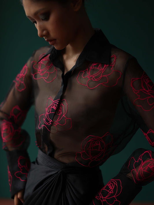 Sheer shirt with dimensional roses paired with twist skirt